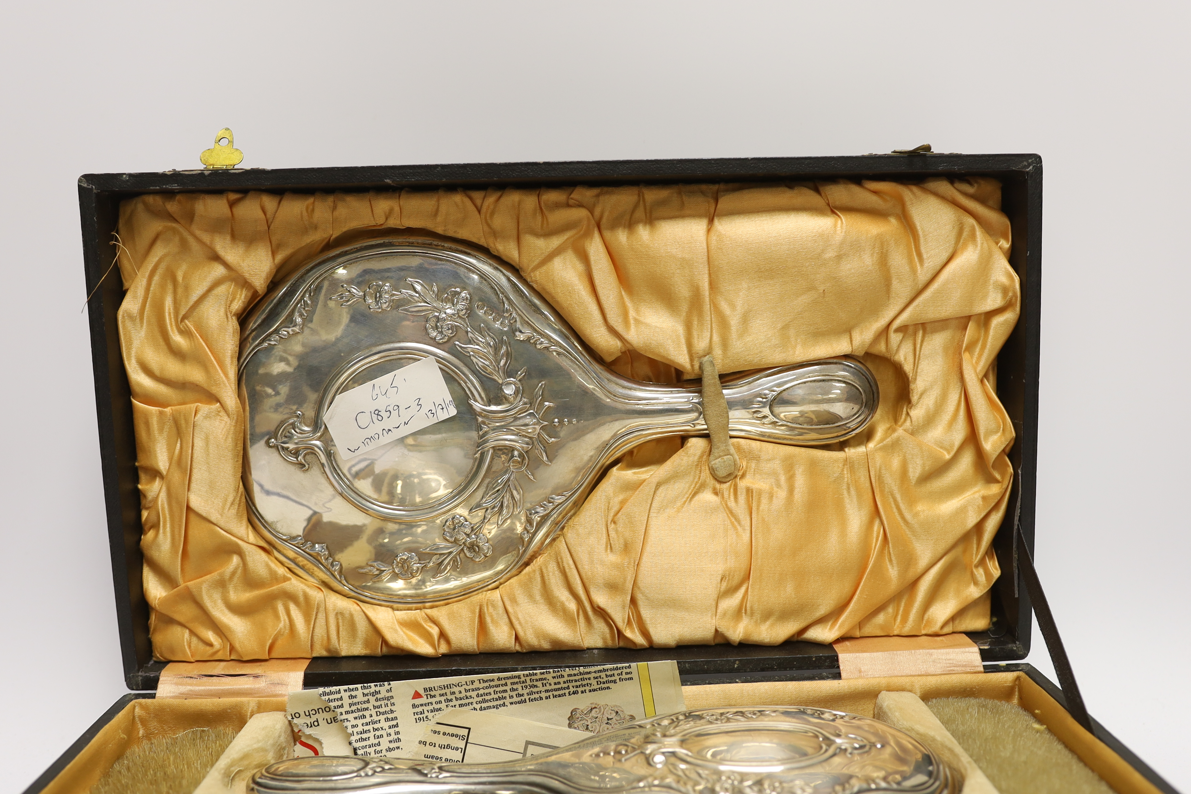 A cased silver four piece dressing table set.